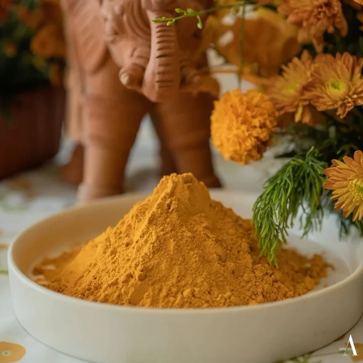 A bowl of fresh turmeric with marigolds